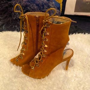 Steve Madden women’s peek toe, string up, heel boot.